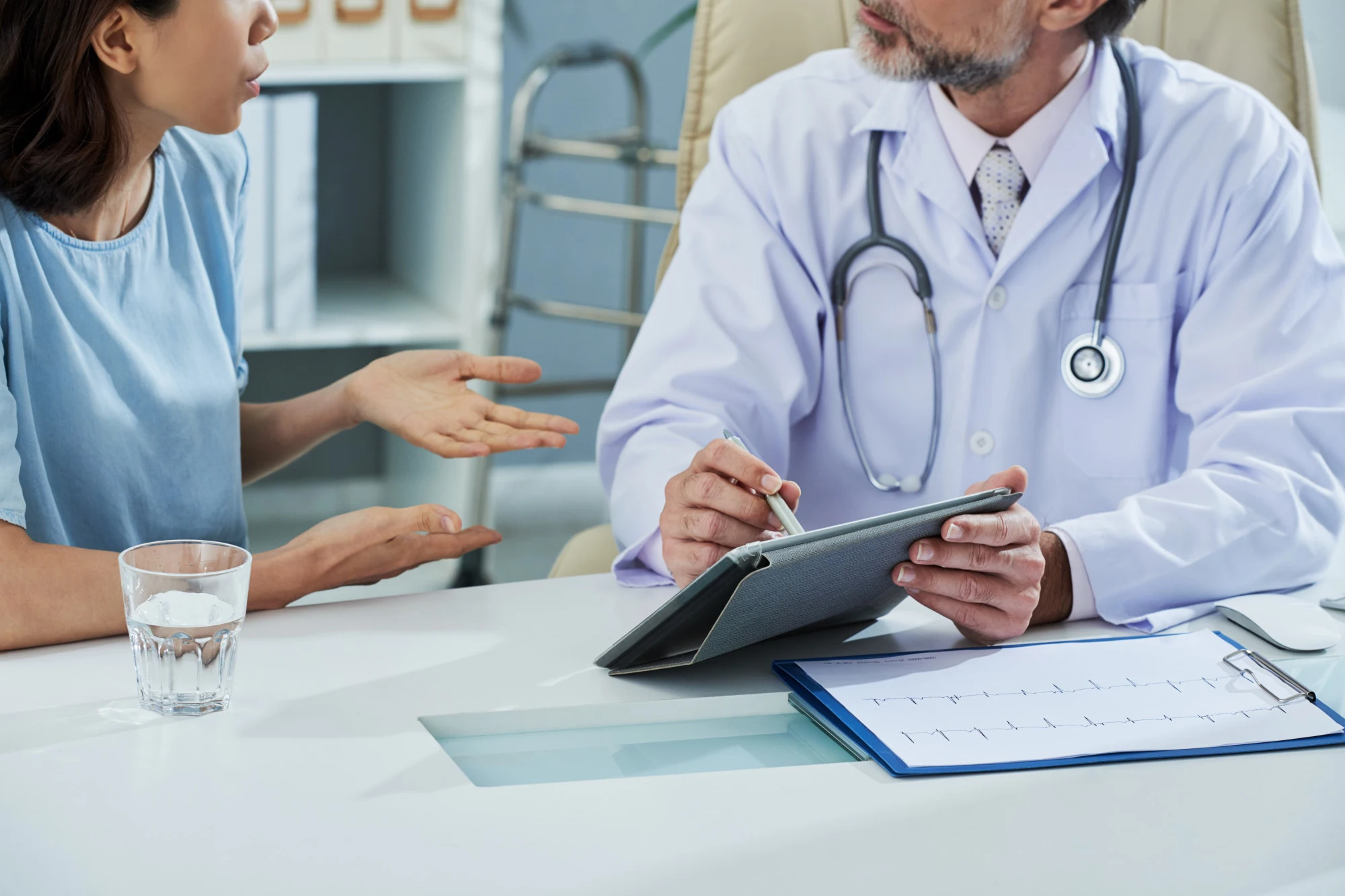 doctor-pointing-digital-tablet-screen-while-explai
